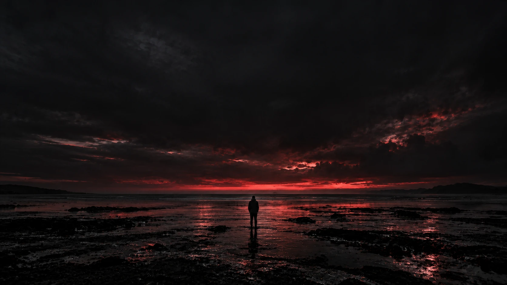 A lone figure facing an open shoreline beneath a dark crimson sky